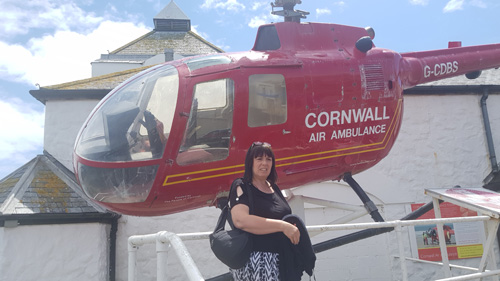 nap a unique selfie outside Land's End with a helicopter in the background. Capture the iconic westernmost point of Cornwall along with the dramatic coastal views and aerial excitement.