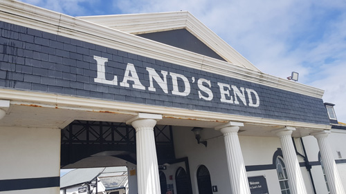 njoy the captivating view from the entrance of Land's End, Cornwall. Experience the dramatic cliffs and sweeping coastal scenery as you arrive at this iconic landmark.