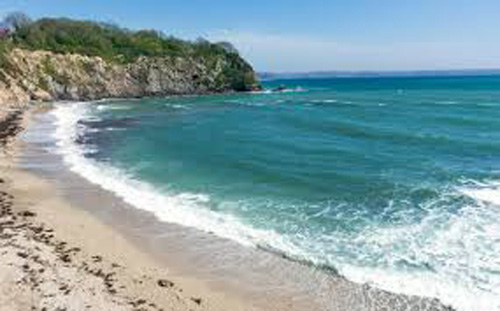 Discover the captivating view of St Austell Bay in Cornwall. Enjoy the sweeping golden sands, clear blue waters, and scenic coastal cliffs that define this picturesque bay and popular seaside destination