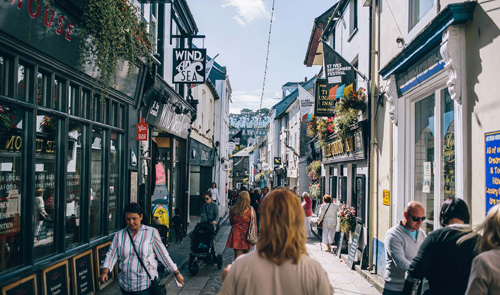 A vibrant and engaging photo of the bustling town centre of St Ives. The image captures the lively atmosphere of the town, featuring historic architecture, quaint shops, and local streets. Ideal for those interested in urban landscapes, travel, and cultural exploration