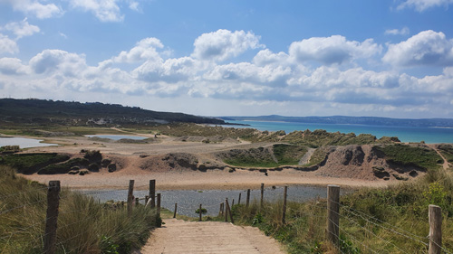 A captivating photo capturing a scenic walk through St Ives leading to its beautiful beach. The image showcases the charming streets of St Ives, vibrant coastal scenery, and inviting beach atmosphere. Ideal for those interested in travel, seaside destinations, and picturesque landscape