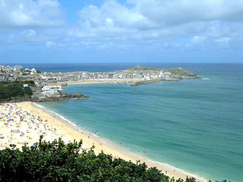 A breathtaking photo showcasing the panoramic view from the cliffs of St Ives. The image highlights the dramatic coastal landscape, with sweeping views of the turquoise waters and rugged cliff edges. Ideal for enthusiasts of nature, travel, and scenic vistas
