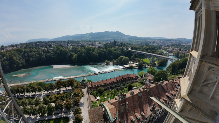 Bern Cathedral with views of the serene river and charming cityscape at sunset