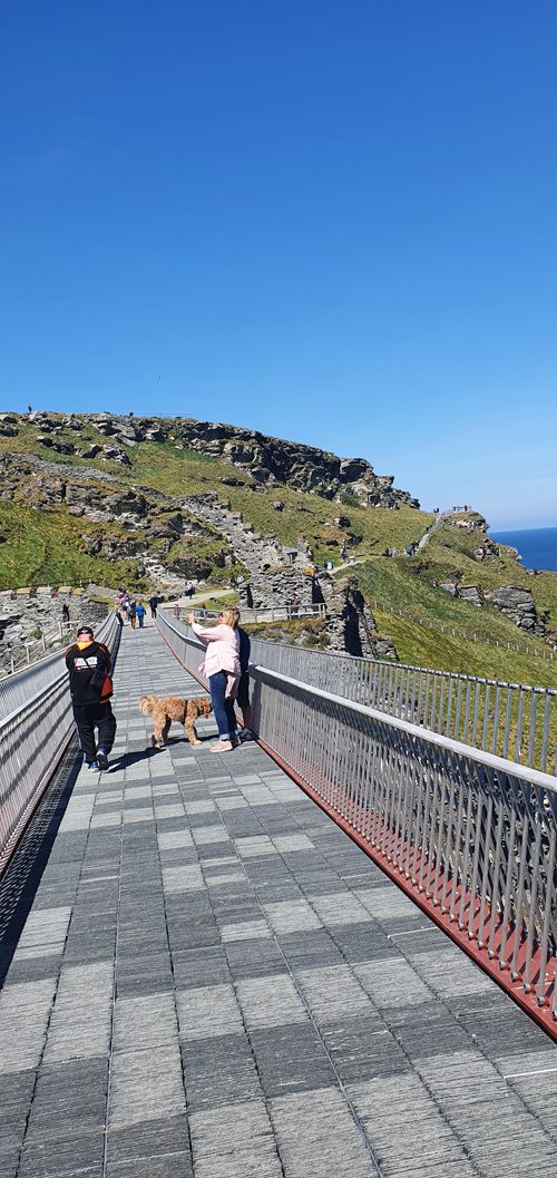 Discover the breathtaking views of Tintagel Castle from the bridge. Enjoy stunning perspectives of the historic ruins perched on dramatic cliffs, overlooking the rugged coastline and the Atlantic Ocean