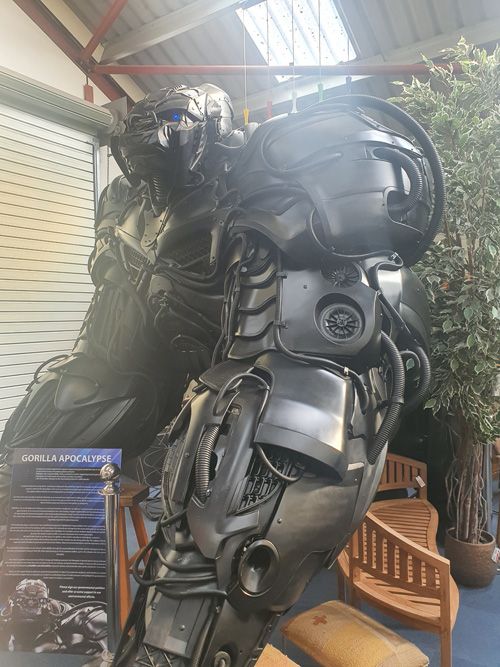 A detailed metal sculpture of a mechanical gorilla at the British Ironwork Centre, featuring intricate gears and components that form its powerful, lifelike pose.