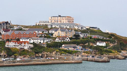 Experience the stunning view of the Newquay coast in Cornwall. Enjoy expansive vistas of rugged cliffs, sandy beaches, and the sparkling Atlantic Ocean, showcasing the dramatic natural beauty of this popular seaside destination.