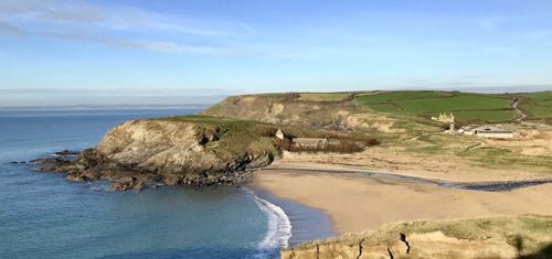 Discover Gunwalloe Beach in Cornwall, a stunning coastal spot with golden sands, clear waters, and scenic beauty perfect for a tranquil escape