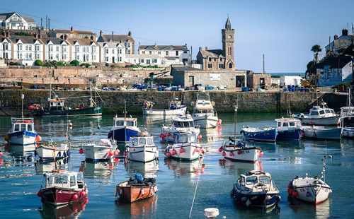 Explore Porthleven Harbour in Cornwall. Enjoy breathtaking coastal views, vibrant local shops, and fresh seafood in this picturesque fishing village
