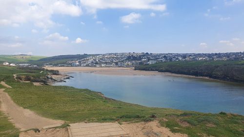 Take in the breathtaking view over Newquay Bay in Cornwall. Enjoy expansive vistas of golden sands, rolling waves, and dramatic cliffs, capturing the natural beauty and coastal charm of this popular seaside location.
