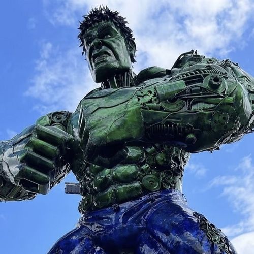 A massive metal sculpture of the Hulk at the British Ironwork Centre, capturing the iconic superhero in a dynamic pose with muscular features and detailed craftsmanship, displayed prominently in the outdoor exhibition area.