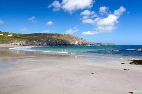 Discover Kennack Sands in Cornwall, a beautiful beach with golden sands, clear waters, and scenic surroundings, perfect for a relaxing day by the sea