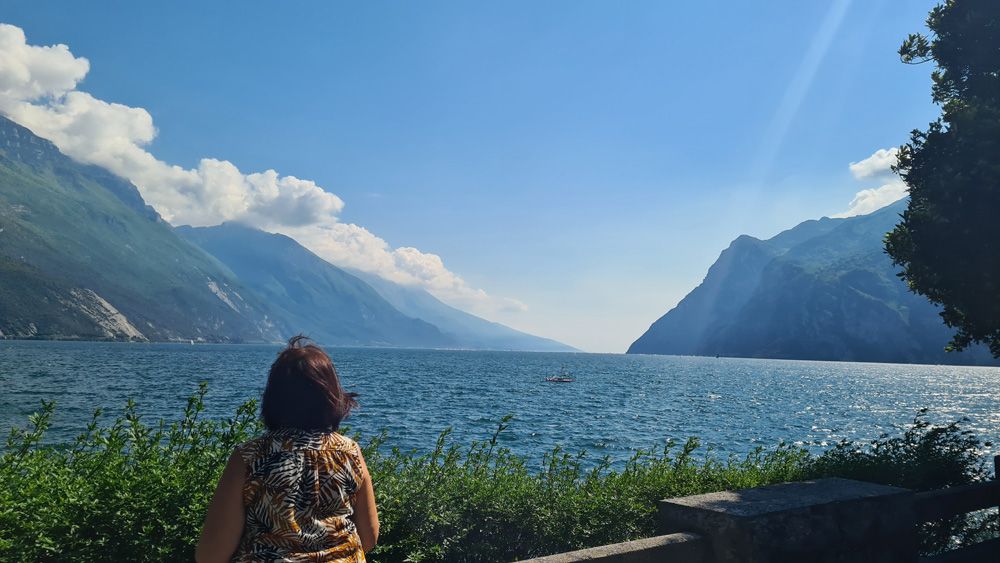 Women admiring the view of mountains and lake garda 