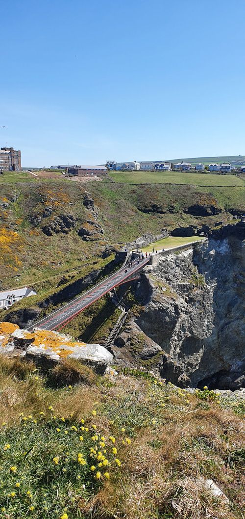Discover breathtaking views from Tintagel Castle Bridge, with sweeping panoramas of the rugged coastline and the Atlantic Ocean. Enjoy a dramatic perspective of the castle's location and the stunning natural beauty of Cornwall.