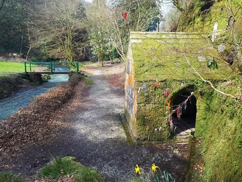 Explore the tranquil view of Menacuddle Well in Cornwall. Discover this historic and picturesque site featuring a charming, ancient well surrounded by lush greenery and serene natural beauty