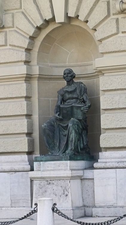 Intricate statue on the façade of Bern Parliament showcasing historical architecture