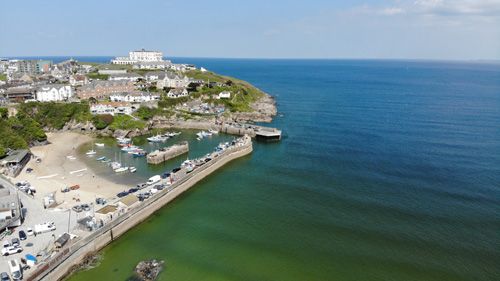 Take in the breathtaking view over Newquay Bay in Cornwall. Enjoy expansive vistas of golden sands, rolling waves, and dramatic cliffs, capturing the natural beauty and coastal charm of this popular seaside location.