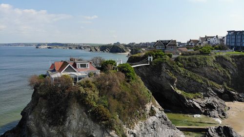 Discover the iconic view of the Famous House Island in Newquay, Cornwall. Admire the picturesque setting and historic charm of this renowned coastal landmark, which stands prominently in the bay.