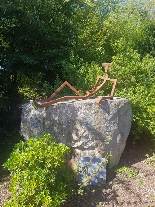 Discover the charming Stickman sculpture at Tremenheere Sculpture Gardens in Cornwall. This playful contemporary art piece blends seamlessly with the lush, subtropical landscape.